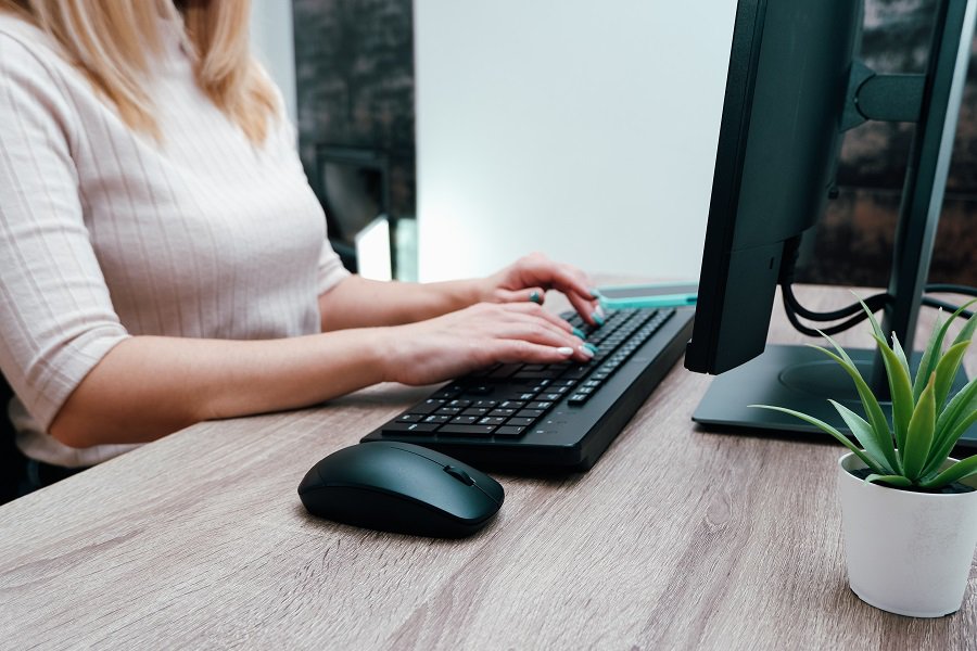 busy woman typing in keyboard
